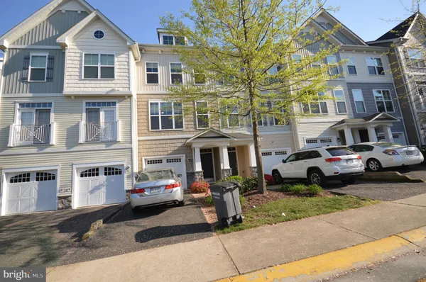 a front view of a residential apartment building with a yard