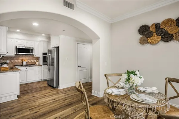 a view of a dining room with furniture and wooden floor