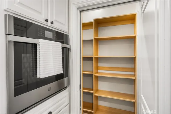 a kitchen with granite countertop a sink a stove and cabinets