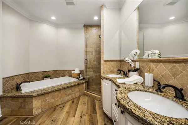 a bathroom with a granite countertop sink a mirror and a toilet