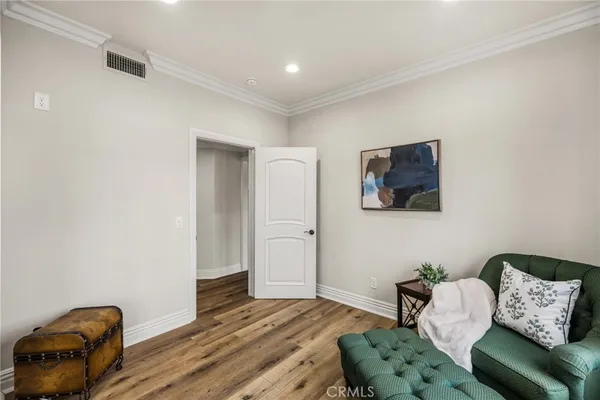 a bedroom with furniture and a wooden floor
