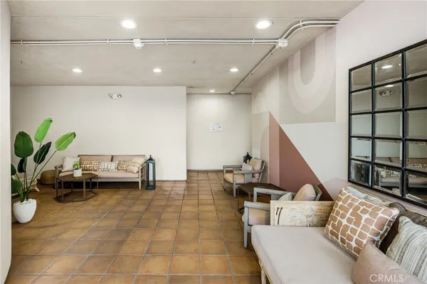 a living room with furniture and a potted plant