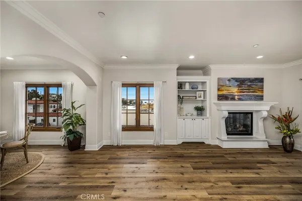 a living room with fireplace furniture and a wooden floor