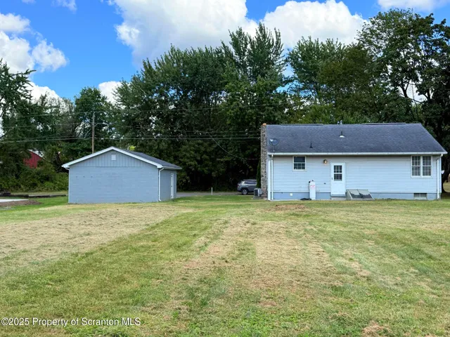 a front view of house with yard and trees
