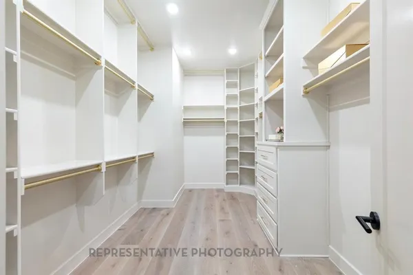 a view of walk in closet with empty racks