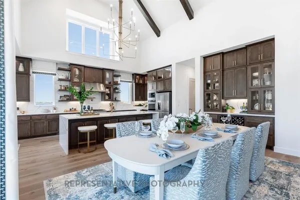 a kitchen with a table chairs stove and cabinets