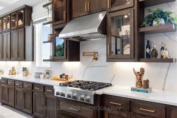 a kitchen with stainless steel appliances a sink stove and cabinets