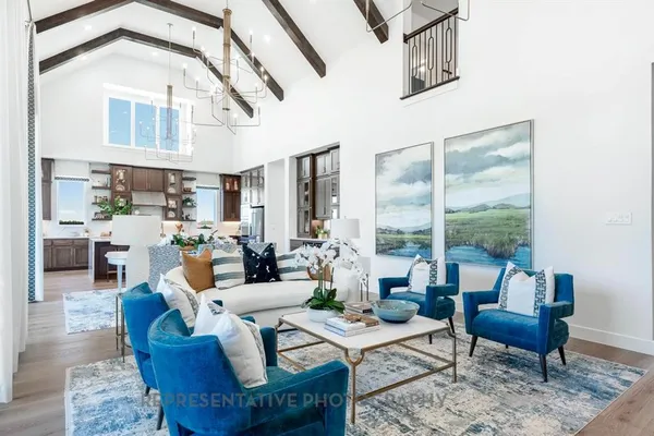a living room with fireplace furniture and a large window
