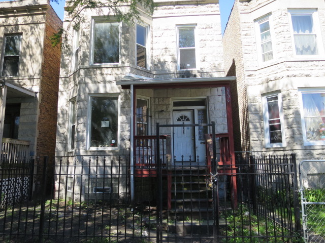 6006 South Carpenter Street Chicago, IL 60621 - Photo 1 of 15 a view of a brick house with large windows
