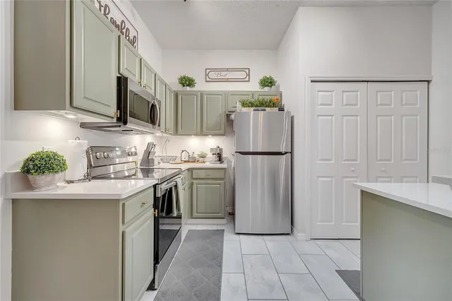 a kitchen with white cabinets and white appliances