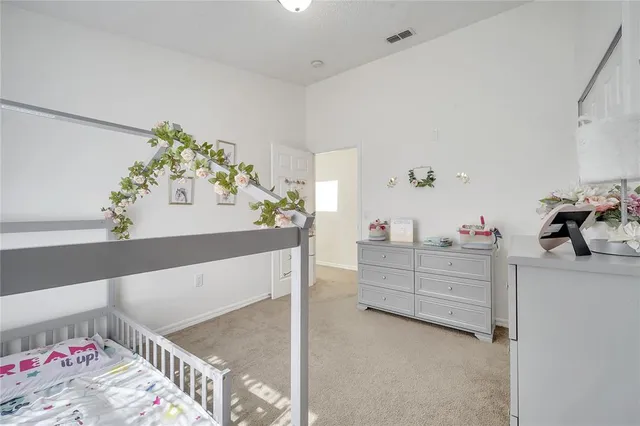 a view of a patio with table and chairs and potted plants