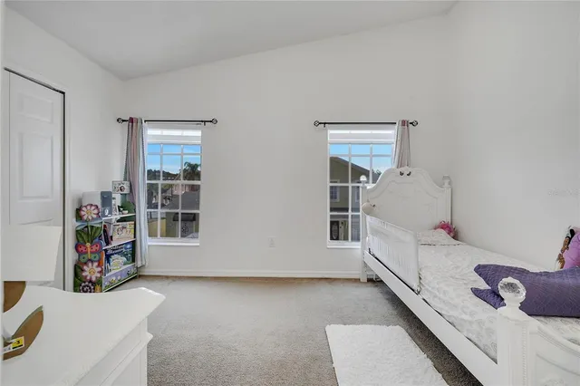 an aerial view of a city with lots of residential buildings and mountain view in back