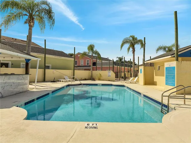 an aerial view of a swimming pool with a garden