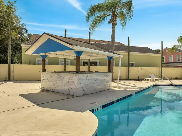 a view of a swimming pool with a yard