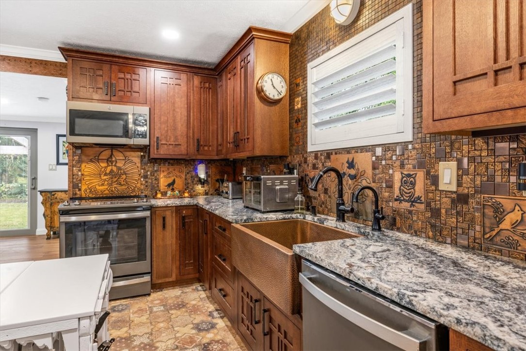 3496 3rd Place Vero Beach, FL 32968 - Photo 14 of 36 a kitchen with a sink stove and cabinets