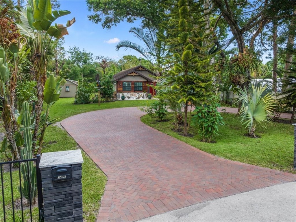 3496 3rd Place Vero Beach, FL 32968 - Photo 2 of 36 a view of a yard with plants and trees