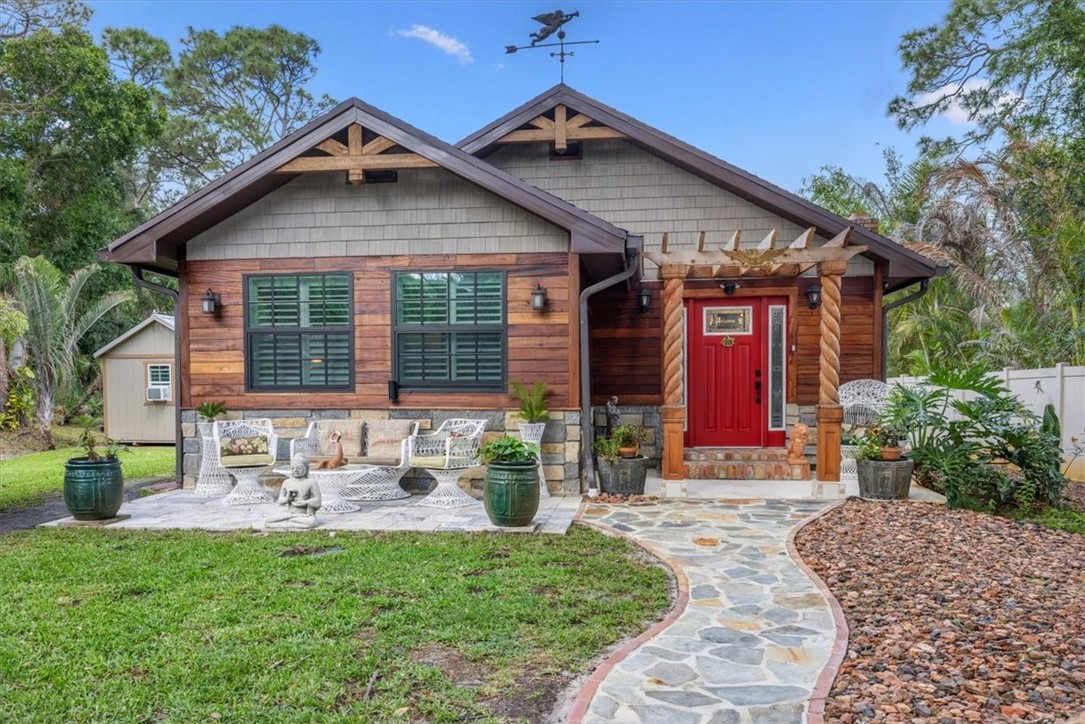 3496 3rd Place Vero Beach, FL 32968 - Photo 4 of 36 a front view of a house with garden