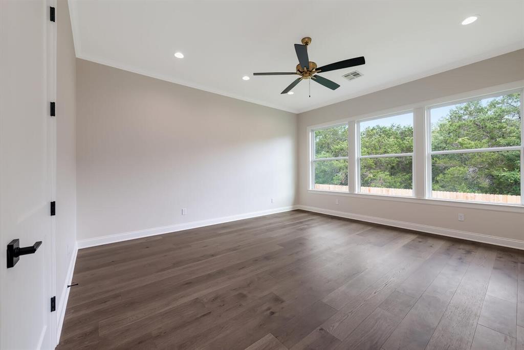 8005 Bee Cave Road China Spring, TX 76633 - Photo 37 of 40 a view of an empty room with wooden floor and a window