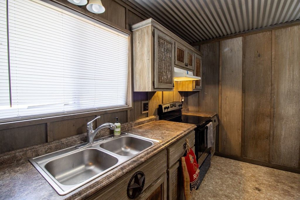 412 Sky Harbor Rd Mountain Mountain Home, TX 78058 - Photo 5 of 16 a kitchen that has a sink and a stove
