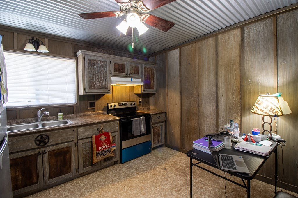 412 Sky Harbor Rd Mountain Mountain Home, TX 78058 - Photo 6 of 16 a kitchen with a stove a refrigerator and a chandelier