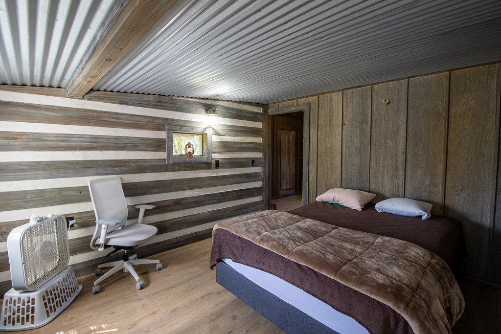 412 Sky Harbor Rd Mountain Mountain Home, TX 78058 - Photo 10 of 16 a bedroom with a bed and a chair