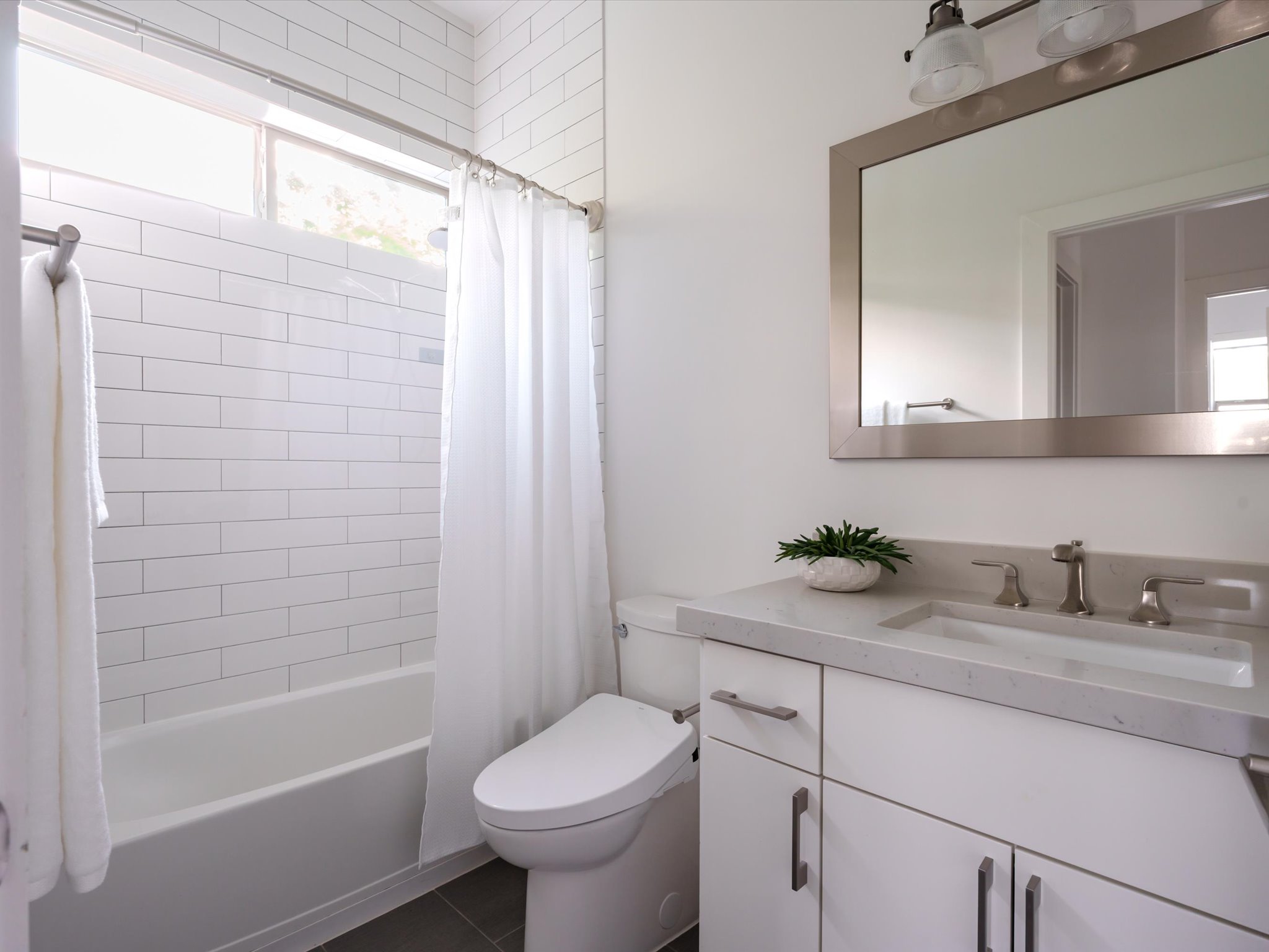 615 Jewell Street Austin, TX 78704 - Photo 18 of 25 The full guest bathroom is chic and modern with the shower and tub giving you that desirable space for a bath.