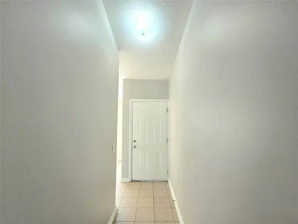 a view of hallway with wooden floor