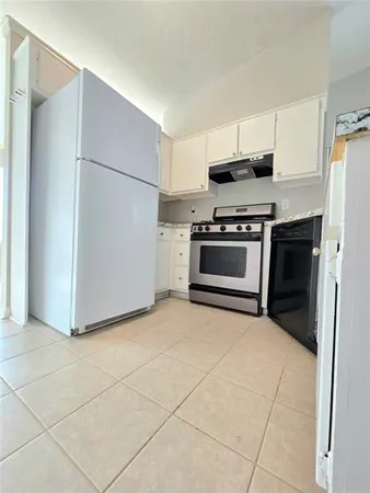 a kitchen with stainless steel appliances granite countertop a refrigerator sink and stove