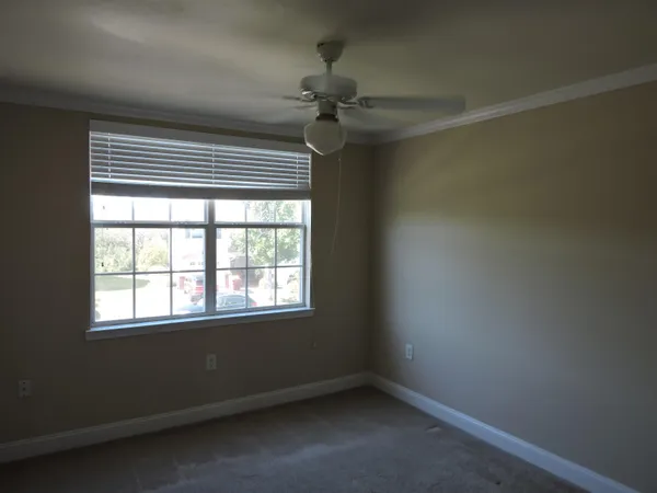 a view of a hallway with a chandelier fan