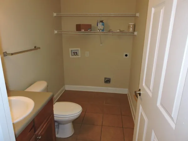 a bathroom with a sink a toilet a tub and shower