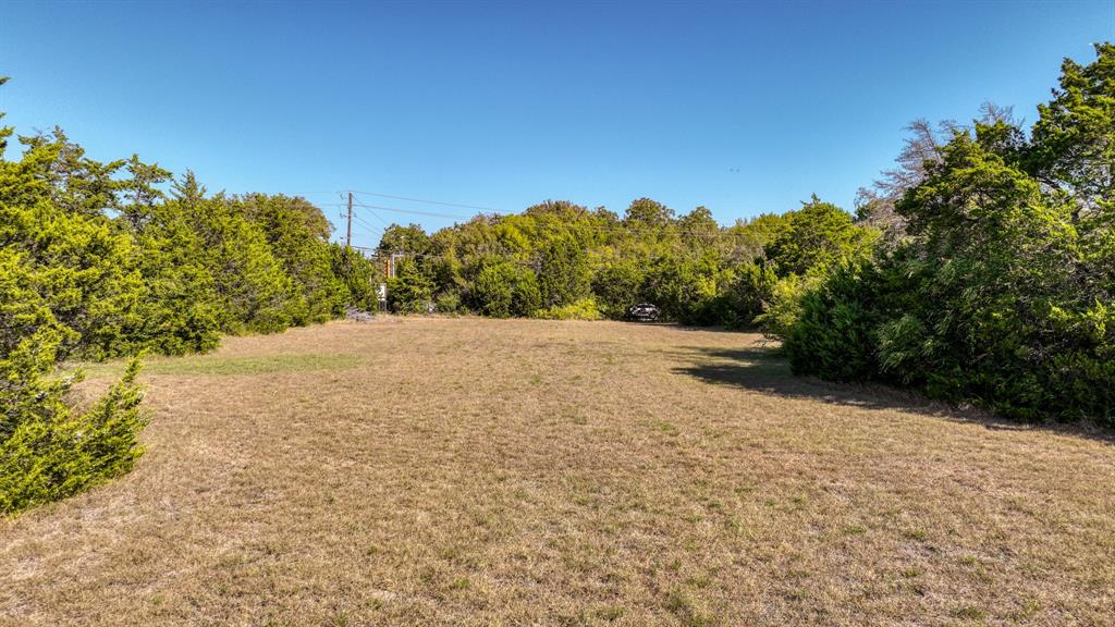 1922 West Pleasant Run Road DeSoto, TX 75115 - Photo 5 of 9 a view of dirt field with trees in background