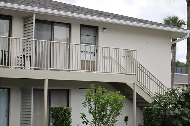 a balcony with wooden floor and a potted plant