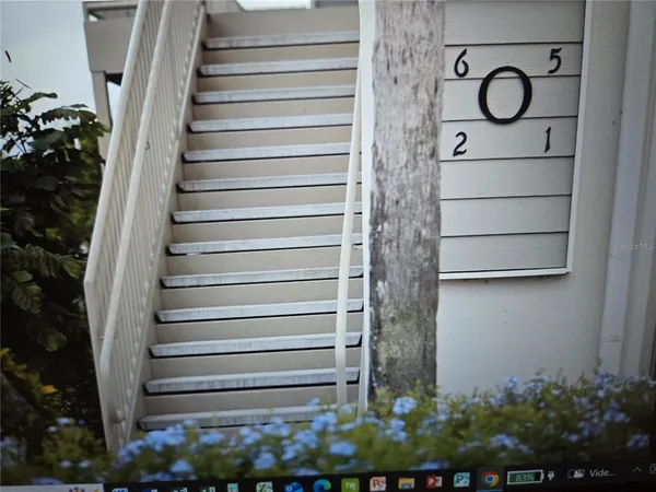 a stairs of a house with wooden fence