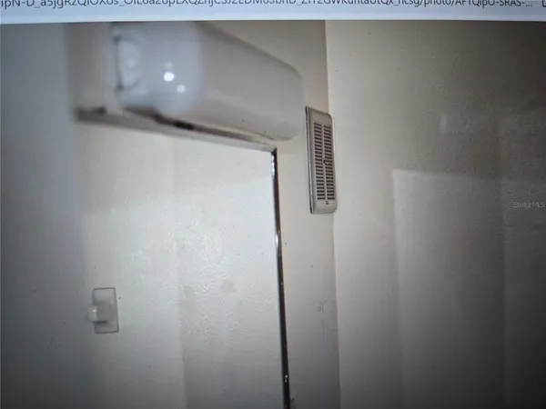 a walk in closet with wooden floor