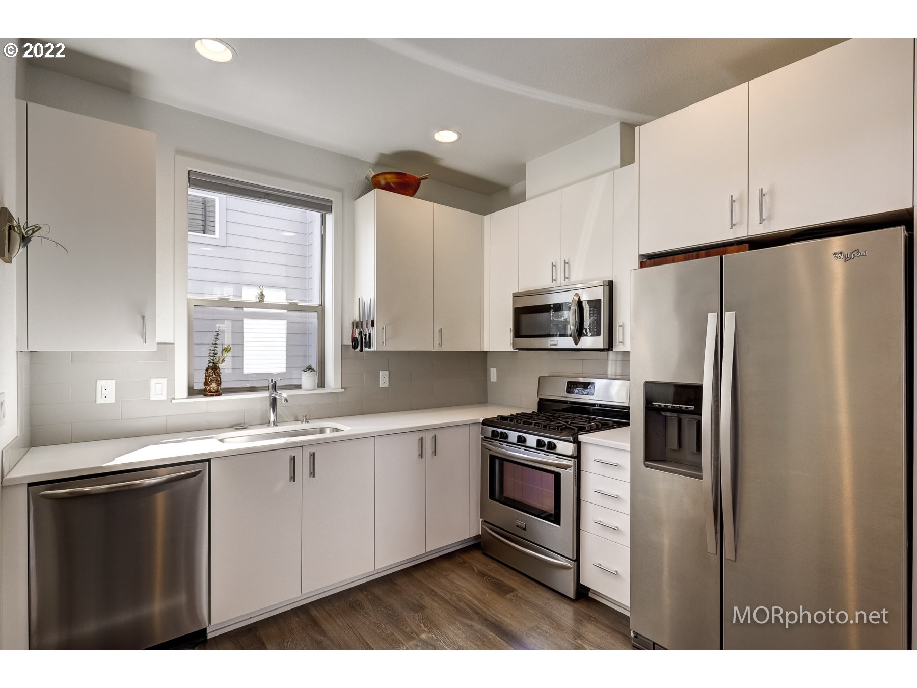 1208 North Morgan Street Portland, OR 97217 - Photo 11 of 23 a kitchen with stainless steel appliances a refrigerator sink and microwave