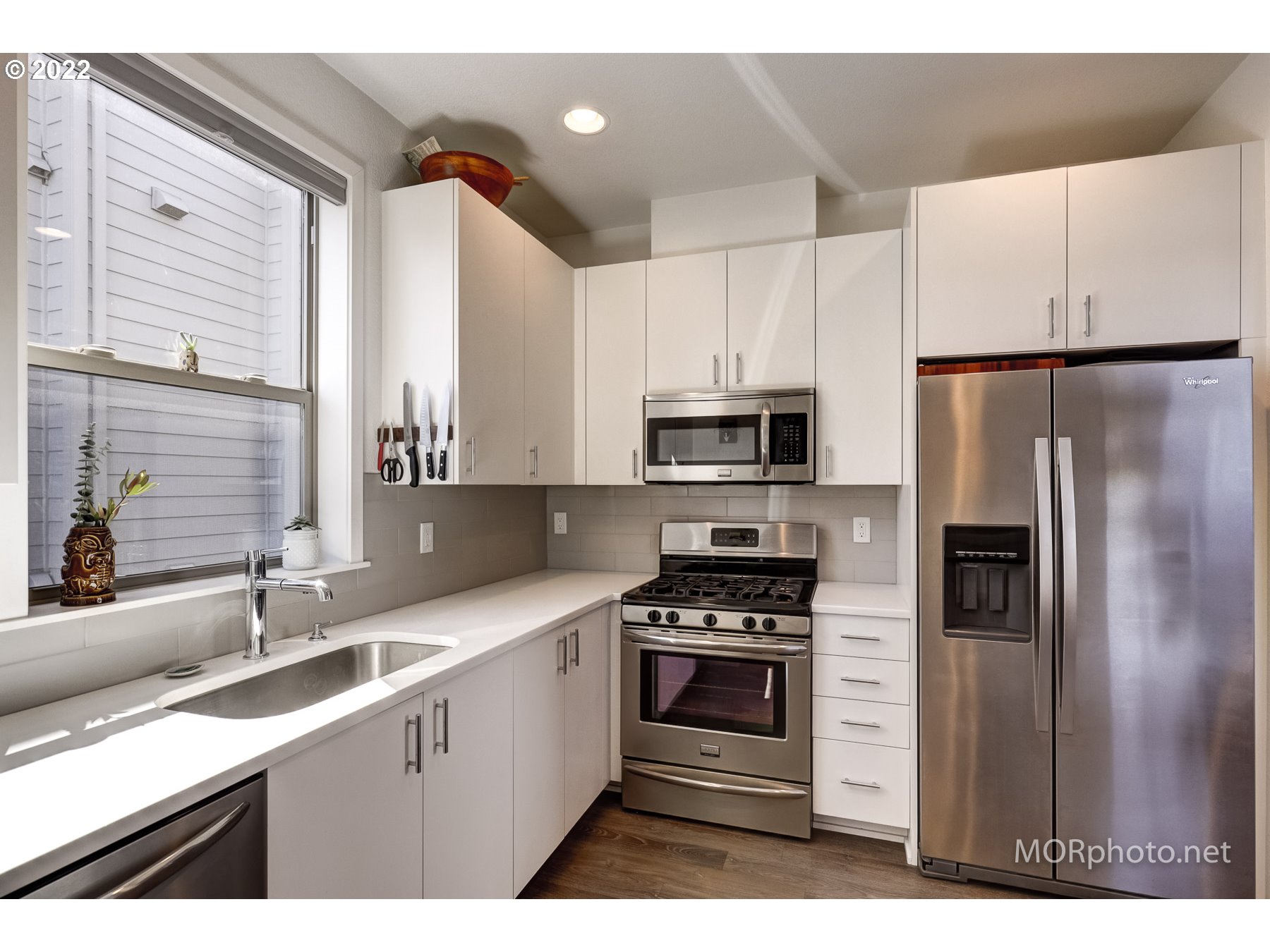 1208 North Morgan Street Portland, OR 97217 - Photo 12 of 23 a kitchen with stainless steel appliances a refrigerator sink and microwave