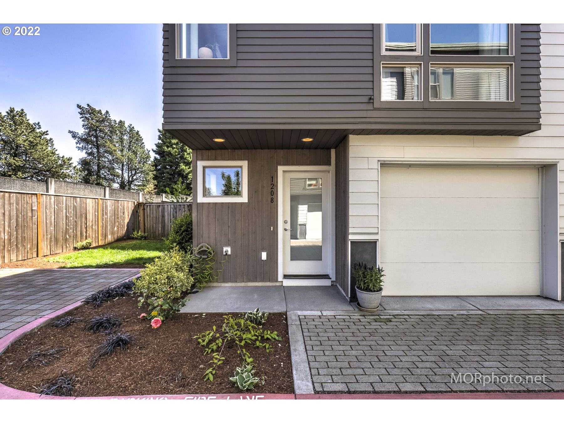 1208 North Morgan Street Portland, OR 97217 - Photo 2 of 23 a view of a backyard with plants and a tree