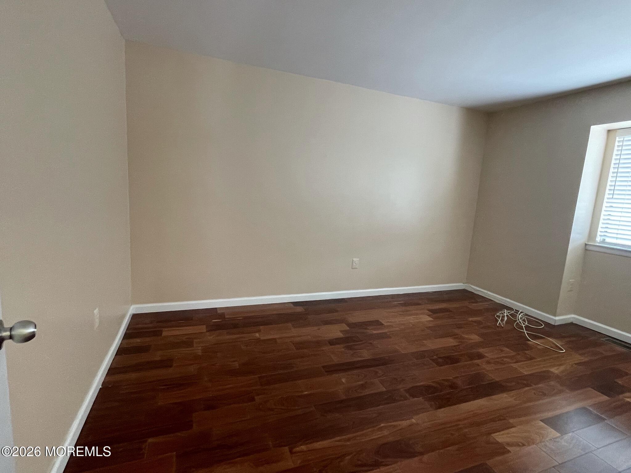 19 Clavendon Court Middletown, NJ 07748 - Photo 16 of 21 a view of room with window and wooden floor