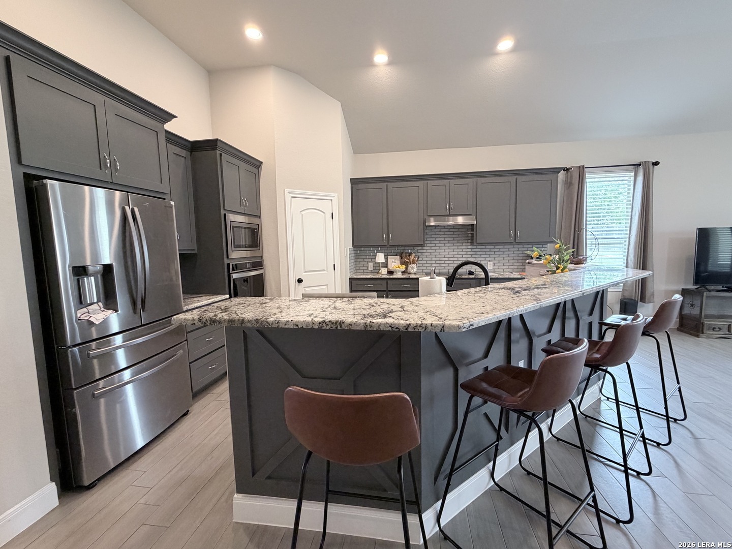 615 Abbott Ridge Converse, TX 78109 - Photo 11 of 26 a kitchen with stainless steel appliances granite countertop a refrigerator a stove a sink and a microwave