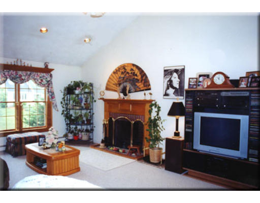 7 Deer Haven Road Beverly, MA 01915 - Photo 3 of 14 a living room with furniture a fireplace and a large window