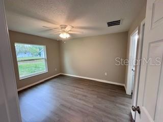 20193 Southwest 83rd Street Dunnellon, FL 34431 - Photo 11 of 31 an empty room with wooden floor fan and windows