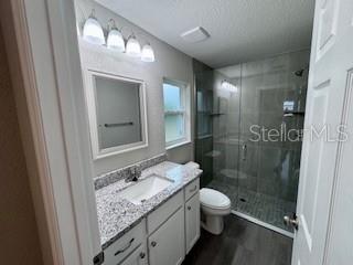 20193 Southwest 83rd Street Dunnellon, FL 34431 - Photo 14 of 31 a bathroom with a granite countertop sink a toilet and shower