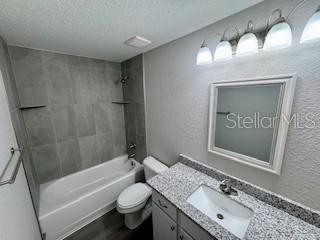 20193 Southwest 83rd Street Dunnellon, FL 34431 - Photo 21 of 31 a bathroom with a granite countertop sink toilet and shower