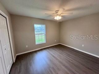 20193 Southwest 83rd Street Dunnellon, FL 34431 - Photo 23 of 31 a view of an empty room with wooden floor and a window
