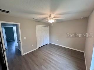 20193 Southwest 83rd Street Dunnellon, FL 34431 - Photo 25 of 31 an empty room with wooden floor fan and windows