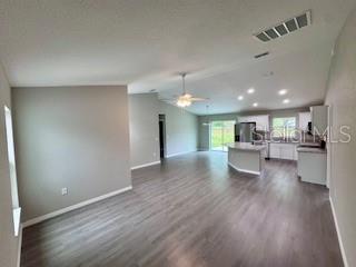 20193 Southwest 83rd Street Dunnellon, FL 34431 - Photo 3 of 31 a view of a living room a kitchen and a wooden floor