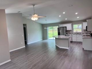 20193 Southwest 83rd Street Dunnellon, FL 34431 - Photo 4 of 31 a view of a kitchen and dining room with wooden floor a chandelier