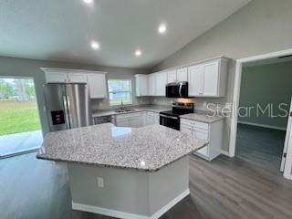 20193 Southwest 83rd Street Dunnellon, FL 34431 - Photo 5 of 31 a kitchen with stainless steel appliances granite countertop a sink refrigerator and microwave
