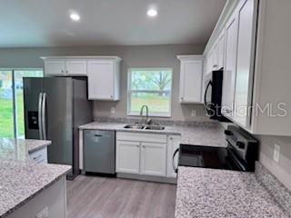 20193 Southwest 83rd Street Dunnellon, FL 34431 - Photo 6 of 31 a kitchen with a sink stove and refrigerator