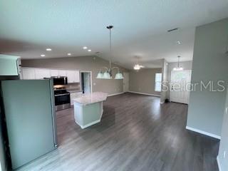 20193 Southwest 83rd Street Dunnellon, FL 34431 - Photo 7 of 31 a view of a kitchen with a sink and a refrigerator